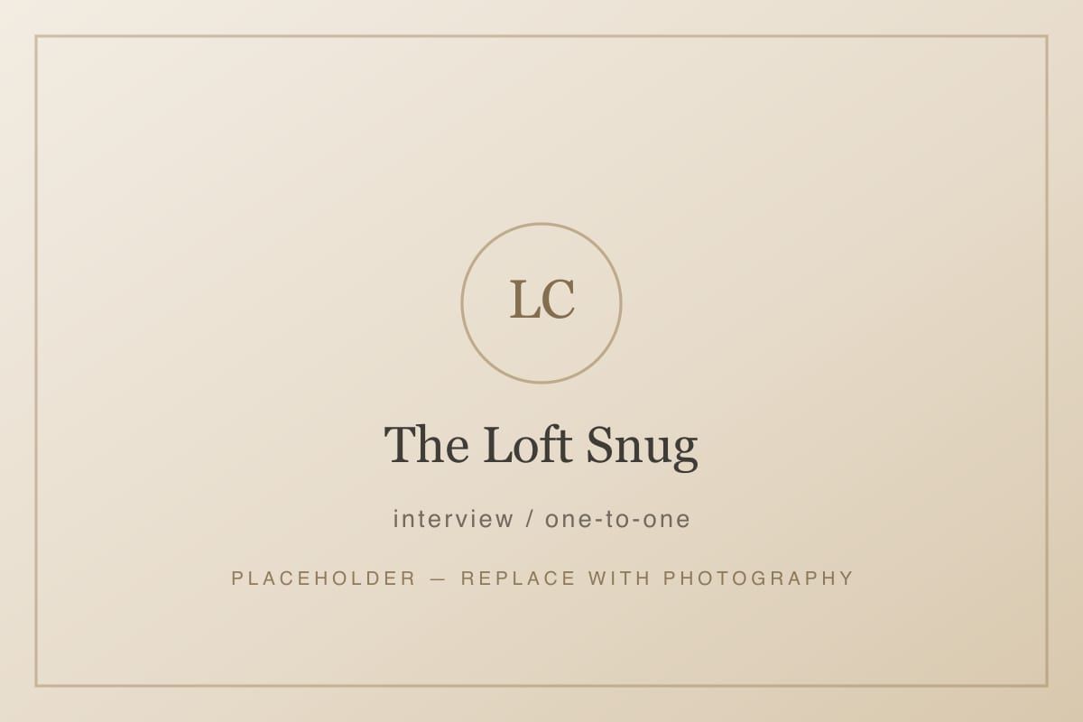 The Loft Snug set up for a one-to-one meeting, with two armchairs beside the balcony doors.