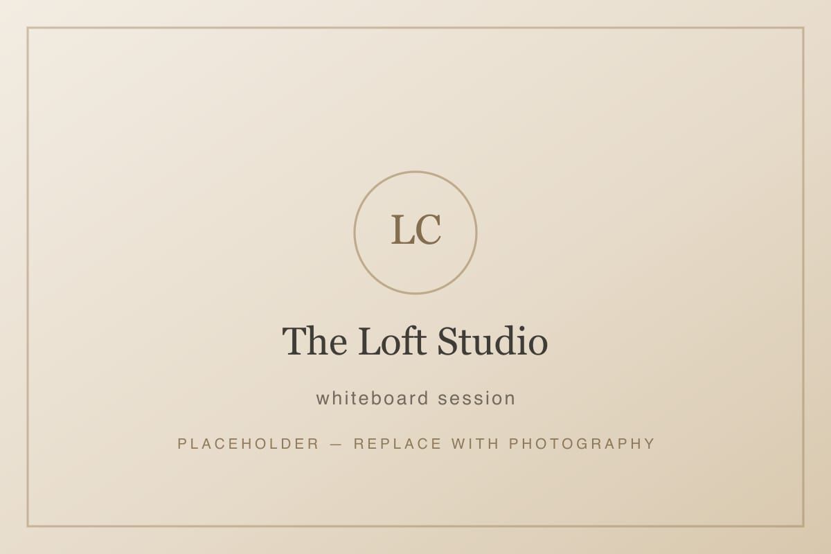 The Loft Studio with a whiteboard covered in notes and four chairs drawn around a table.